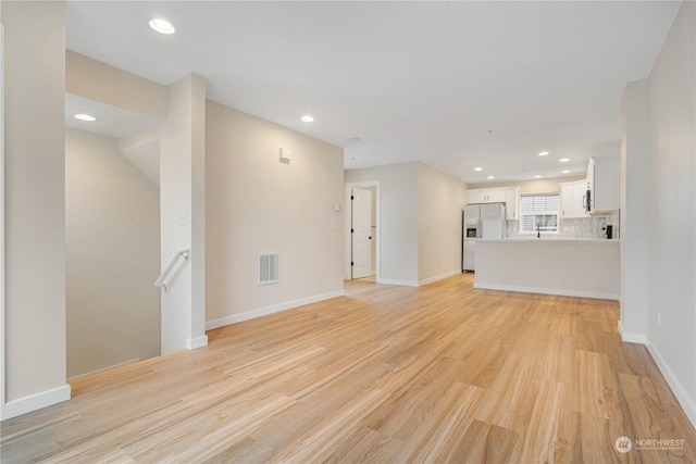 unfurnished living room with light wood-type flooring