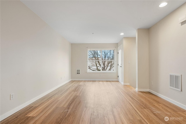 spare room with light wood-type flooring