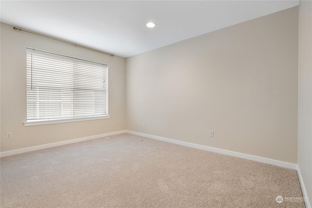 unfurnished room with light carpet