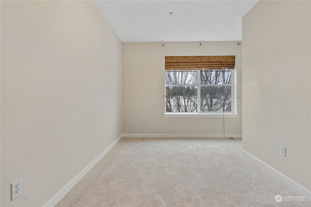 empty room featuring light colored carpet