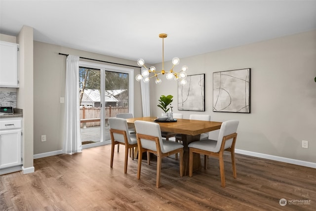 dining area featuring an inviting chandelier and light hardwood / wood-style floors