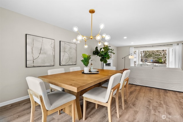 dining space with a chandelier and light wood-type flooring