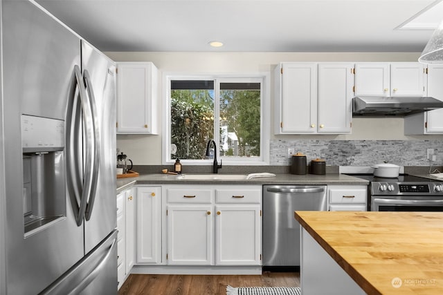 kitchen featuring dark wood-type flooring, sink, white cabinetry, wooden counters, and stainless steel appliances