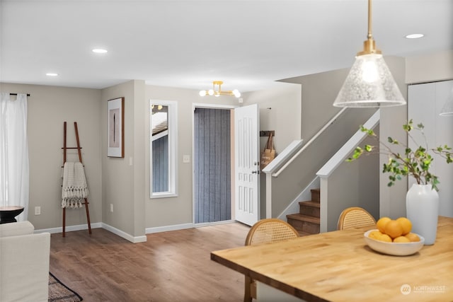 dining room with hardwood / wood-style floors and a notable chandelier