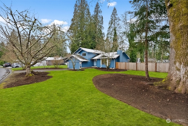 view of front of home with a garage and a front lawn