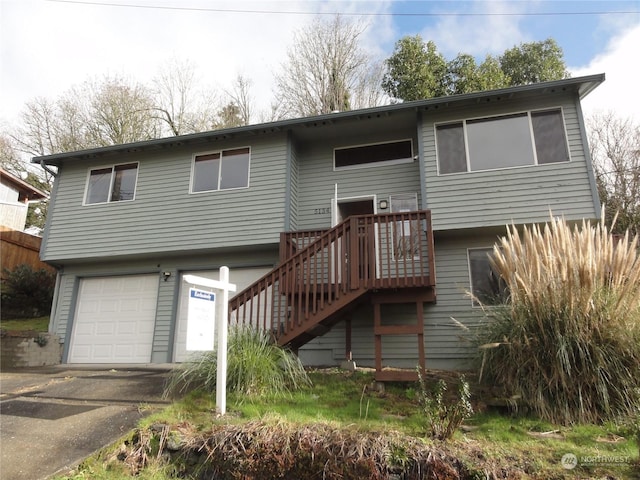 rear view of property featuring a garage