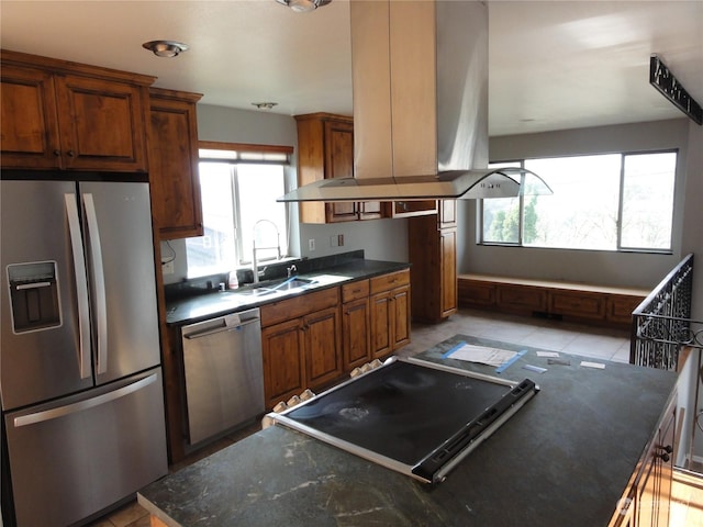 kitchen featuring a kitchen island, island exhaust hood, appliances with stainless steel finishes, and sink