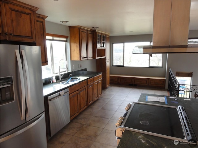 kitchen with light tile patterned flooring, appliances with stainless steel finishes, and sink