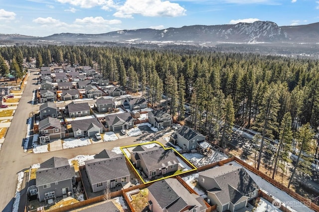 birds eye view of property featuring a residential view, a mountain view, and a view of trees