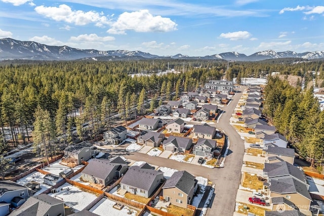 aerial view with a residential view, a mountain view, and a view of trees