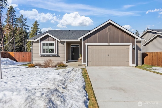 ranch-style house featuring board and batten siding, concrete driveway, fence, and an attached garage