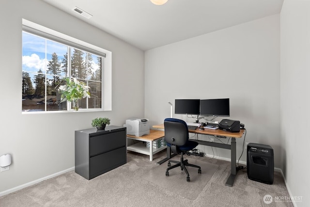 carpeted office space featuring visible vents and baseboards