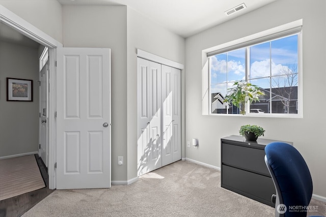 office area with carpet floors, visible vents, and baseboards