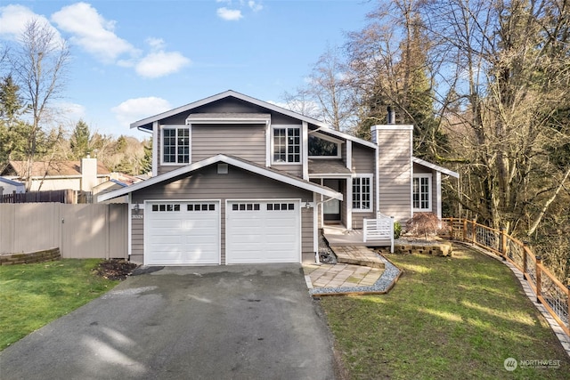 view of front of home featuring a garage and a front yard