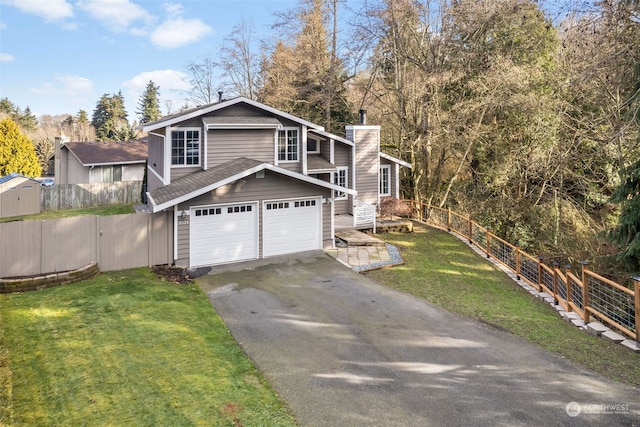 view of front of home featuring a garage and a front lawn