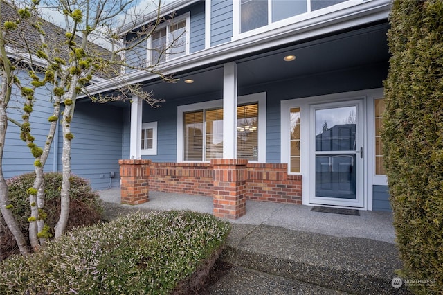 view of exterior entry with covered porch