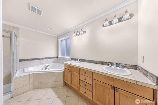 full bath with crown molding, visible vents, a sink, and tile patterned floors