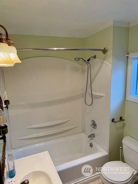 bathroom featuring crown molding, shower / washtub combination, and toilet