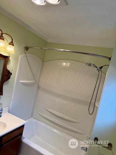 bathroom with ornamental molding, vanity, and tub / shower combination