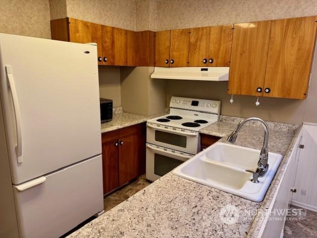 kitchen featuring sink and white appliances