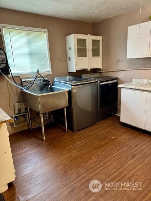 kitchen with white cabinetry, sink, dark hardwood / wood-style flooring, and independent washer and dryer