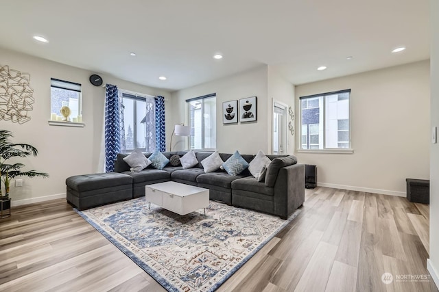 living room featuring plenty of natural light and light hardwood / wood-style floors