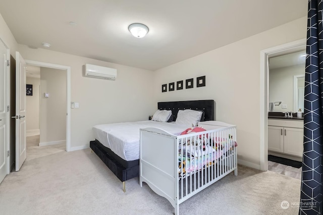 bedroom featuring a wall mounted air conditioner, sink, and light carpet