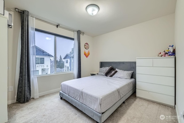 bedroom featuring light colored carpet