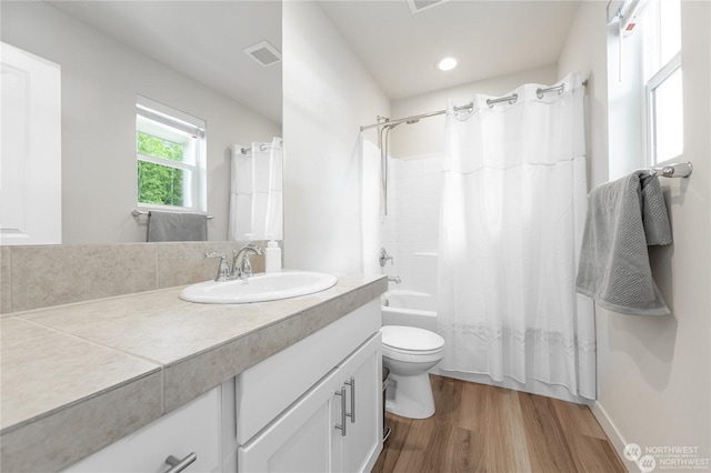 full bathroom featuring shower / tub combo with curtain, vanity, toilet, and hardwood / wood-style floors