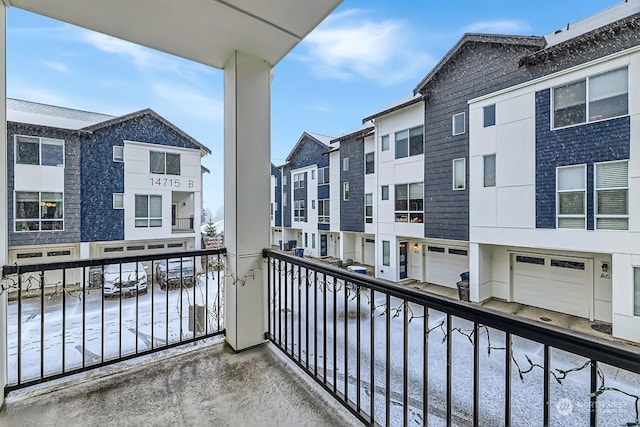 view of snow covered back of property