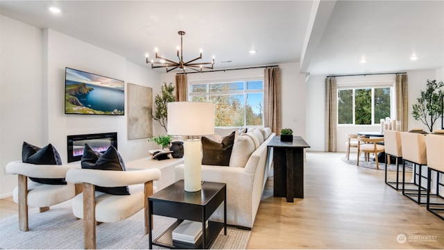 living room featuring light hardwood / wood-style flooring and a notable chandelier