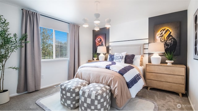 carpeted bedroom featuring a notable chandelier