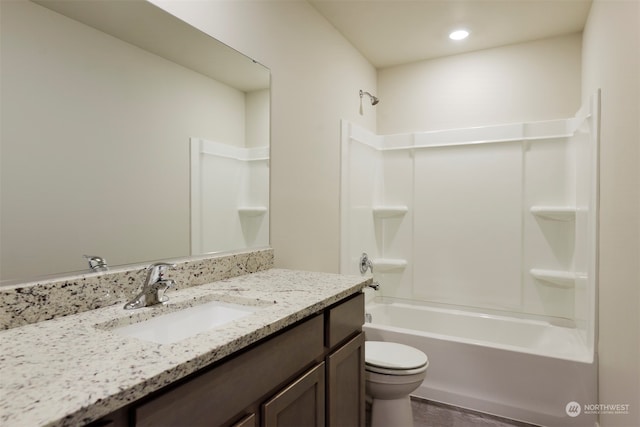 full bathroom featuring toilet, vanity, and bathtub / shower combination