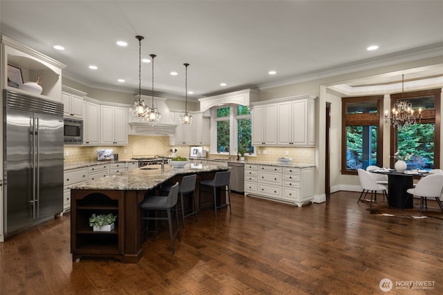 kitchen with ornamental molding, white cabinets, open shelves, and built in appliances