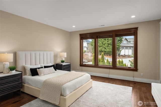 bedroom featuring baseboards, dark wood finished floors, and recessed lighting