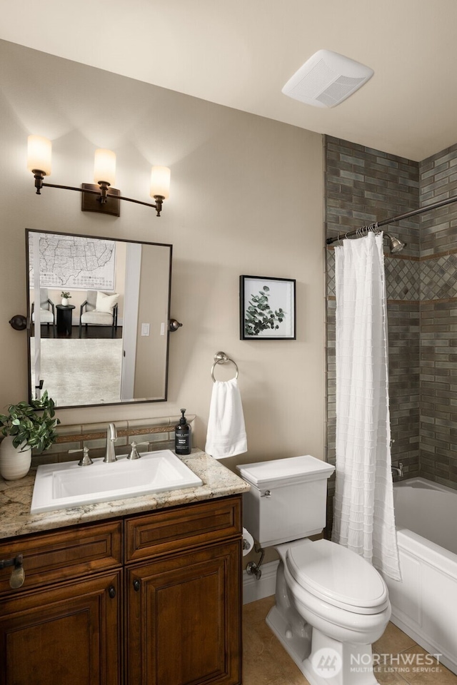 bathroom featuring visible vents, vanity, toilet, and shower / bath combo with shower curtain