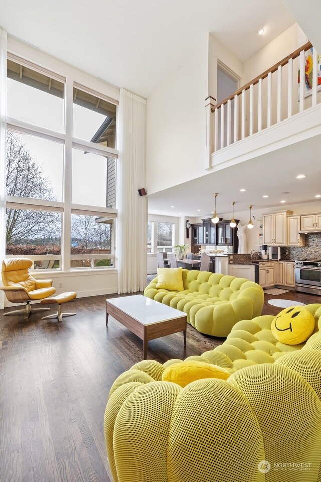 living room featuring a high ceiling and hardwood / wood-style floors