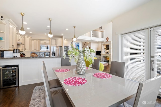 dining area with dark hardwood / wood-style floors and beverage cooler