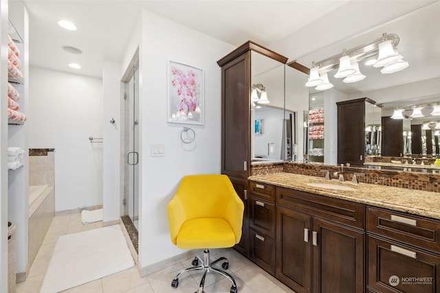 bathroom featuring tile patterned flooring, vanity, tasteful backsplash, and shower with separate bathtub