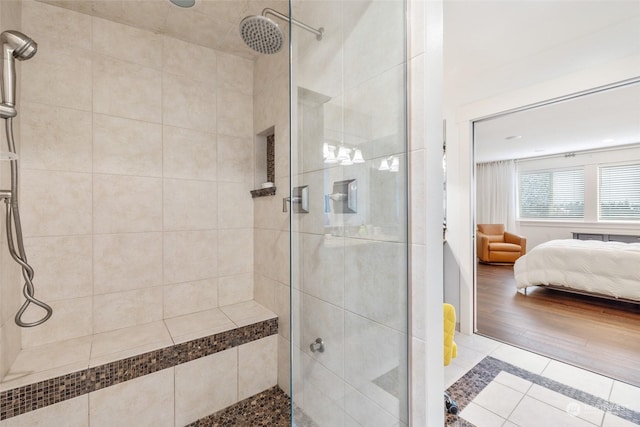 bathroom featuring tile patterned flooring and an enclosed shower