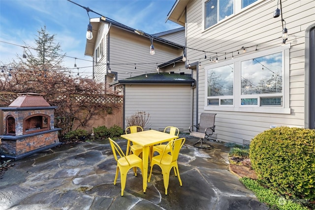 view of patio / terrace featuring an outdoor stone fireplace