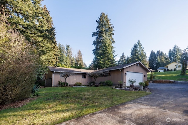 single story home featuring a garage and a front lawn