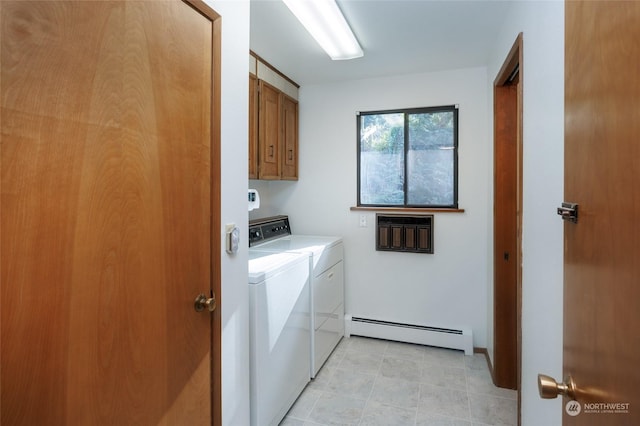 laundry area featuring baseboard heating, cabinets, and separate washer and dryer