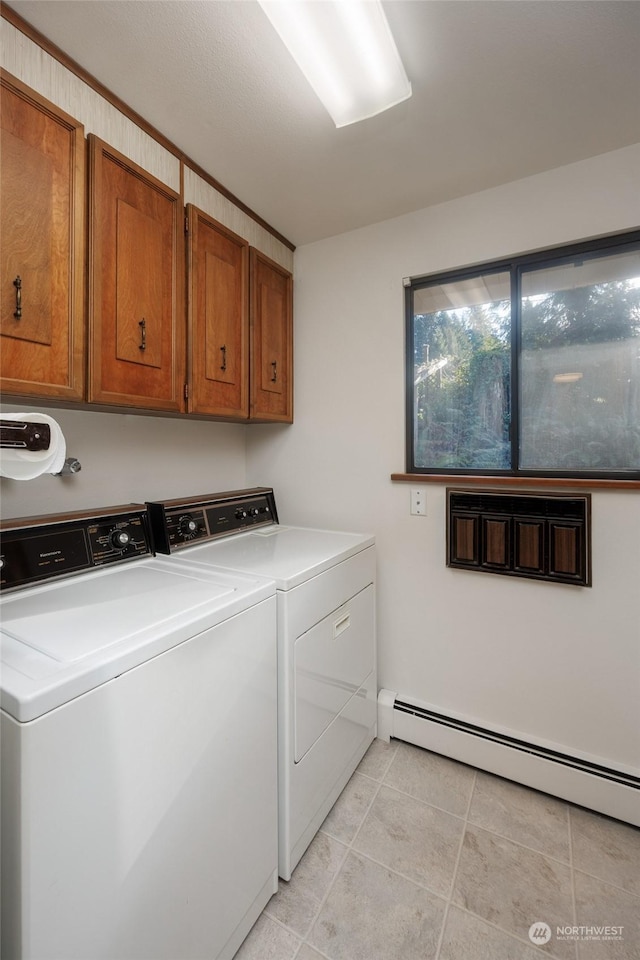 laundry area with cabinets, separate washer and dryer, a baseboard heating unit, and light tile patterned floors