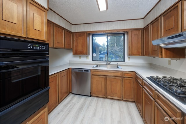 kitchen with sink, oven, stainless steel dishwasher, gas cooktop, and a textured ceiling