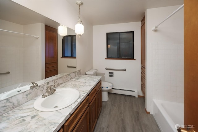 full bathroom with baseboard heating, hardwood / wood-style floors, tiled shower / bath combo, vanity, and toilet