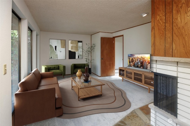 carpeted living room featuring a fireplace and a textured ceiling