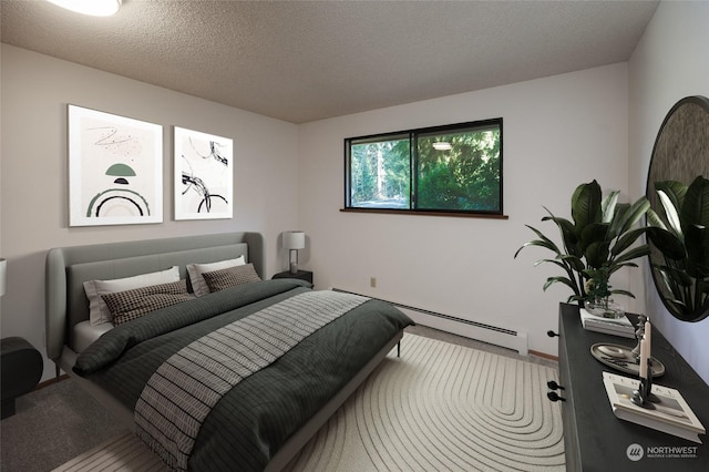 bedroom with a baseboard radiator and a textured ceiling