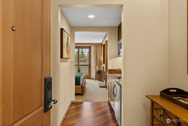 hallway with dark wood-type flooring