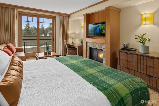 bedroom featuring a fireplace and access to outside